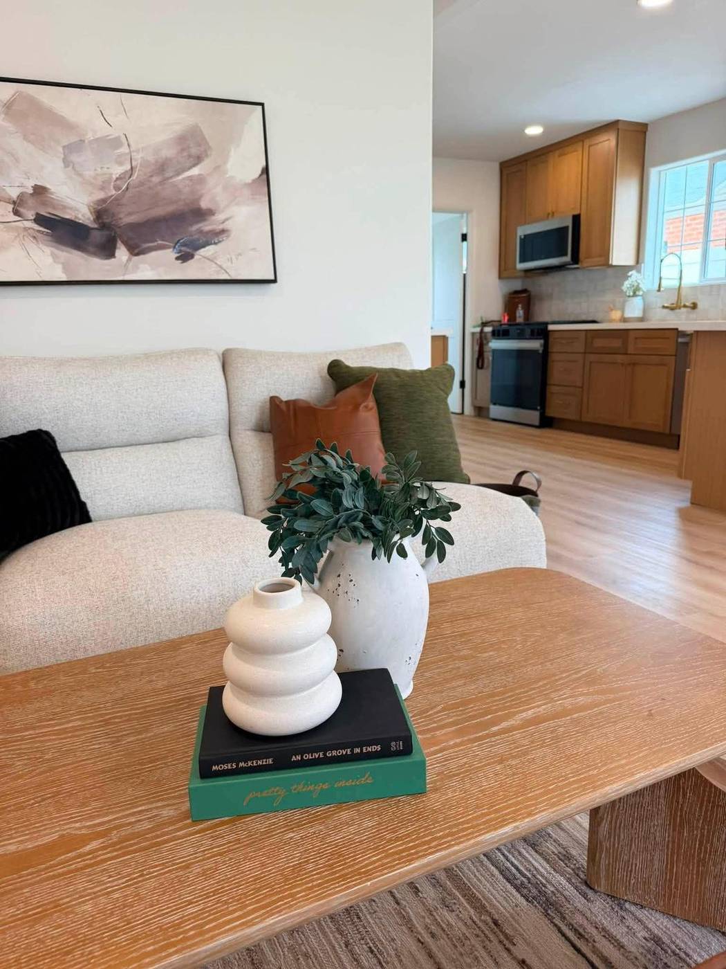 Coffee table vignette with stacked books, a stone sculpture and greenery Coffee table vignette with stacked books, a stone sculpture and greenery