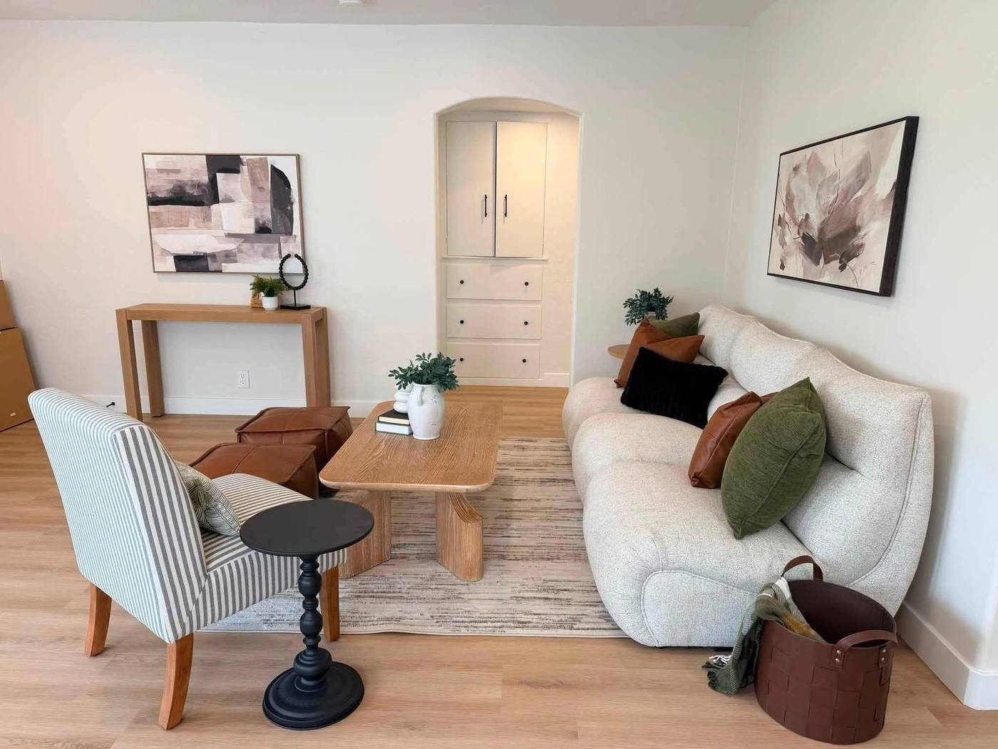 Flex room staged with a boucle sofa, striped accent chair and a writing table