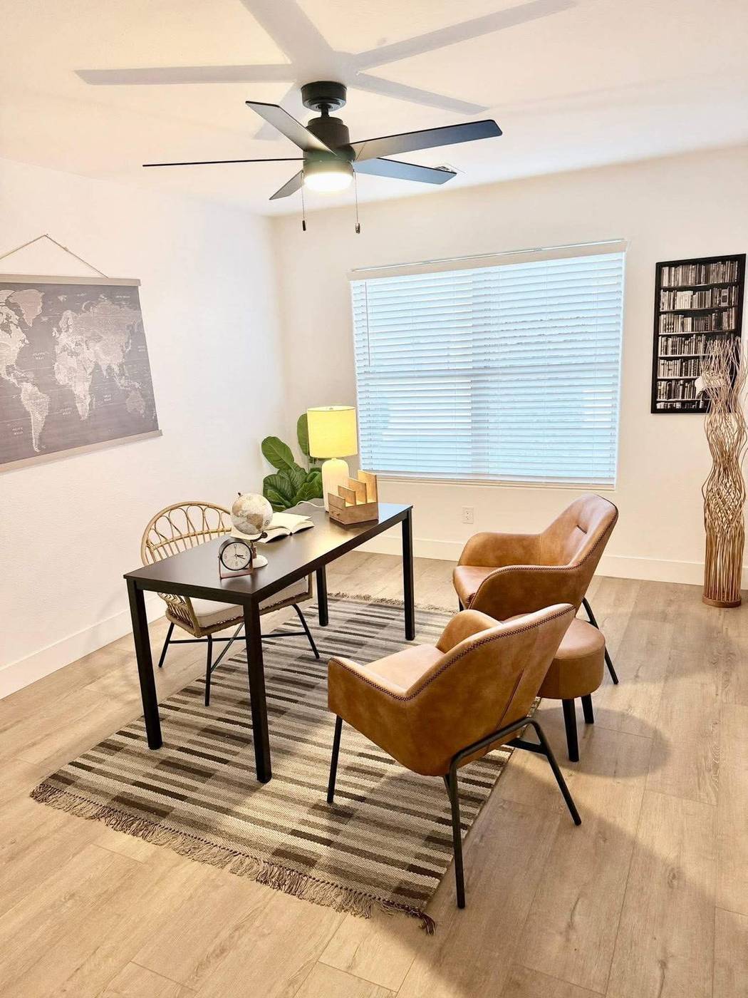 Flex room staged as a home office with a writing desk and two leather chairs in an East Valley listing Flex room staged as a home office with a writing desk and two leather chairs in an East Valley listing